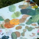 Canvas with several paint swatches from an art activity. 
